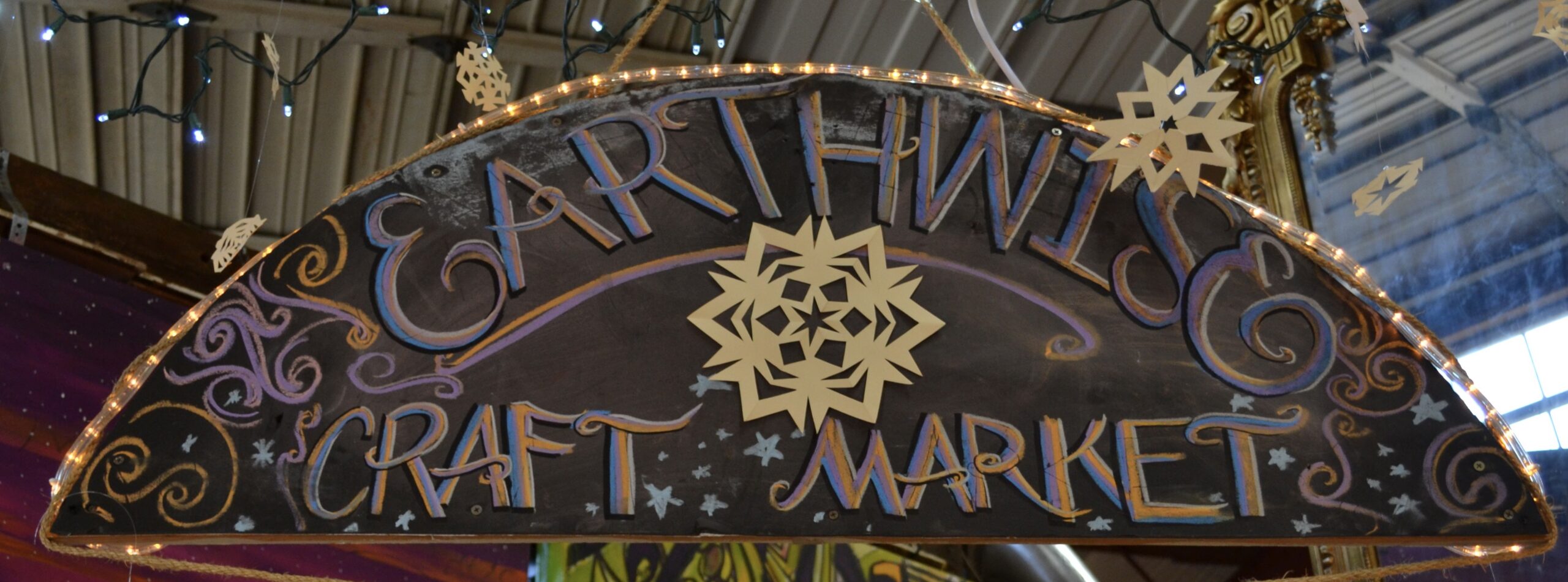 the sign for the Earthwise Craft Market