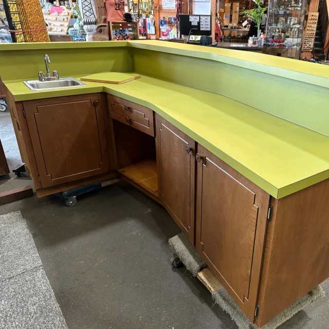"This is a formica (bar top). Green is its color."This incredible vintage built-in wood paneled bar with avocado colored textured counters would have definitely fit right in as a prop on any Twin Peaks episode, perhaps in a wood-paneled basement of sorts. Now it can be yours in all it's 60's/70's glory! Overall it's in fantastic condition, only the side to the left of sink would need to be covered up, or attach it to a wall like it originally was. The open area below was used to store a small fridge. Lots of cupboard space and yes, the SOLO cups are included(!). Don't miss out on this amazing time capsule!Width 53.5" (Sink side) 96" slight V shape, 48" each)Height at counter: 31.5"Height at bar: 42"Depth on sink side: 23"Depth on bar side: 35"Kenmore ID: 95020$1700You can place a 24 hour hold on this item by calling (425) 481-0245 and requesting a hold on item ID 95020#Bar #BarCounter #BarTop #BasementBar #RumpusRoom #RumpusRoomBar #AvacadoFormica #Formica #1960s #1970s #60sDecor #70sDecor #HomeBar #HomeDecor #WetBar #Entertaining #Bars #Booze #Cocktails #Green #AvacadoGreen #Salvage #Earthwise #Kenmore